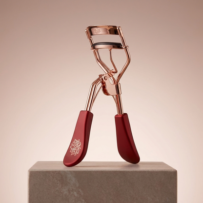 Nuvaressa Classic Eyelash Curler on a stone pedestal